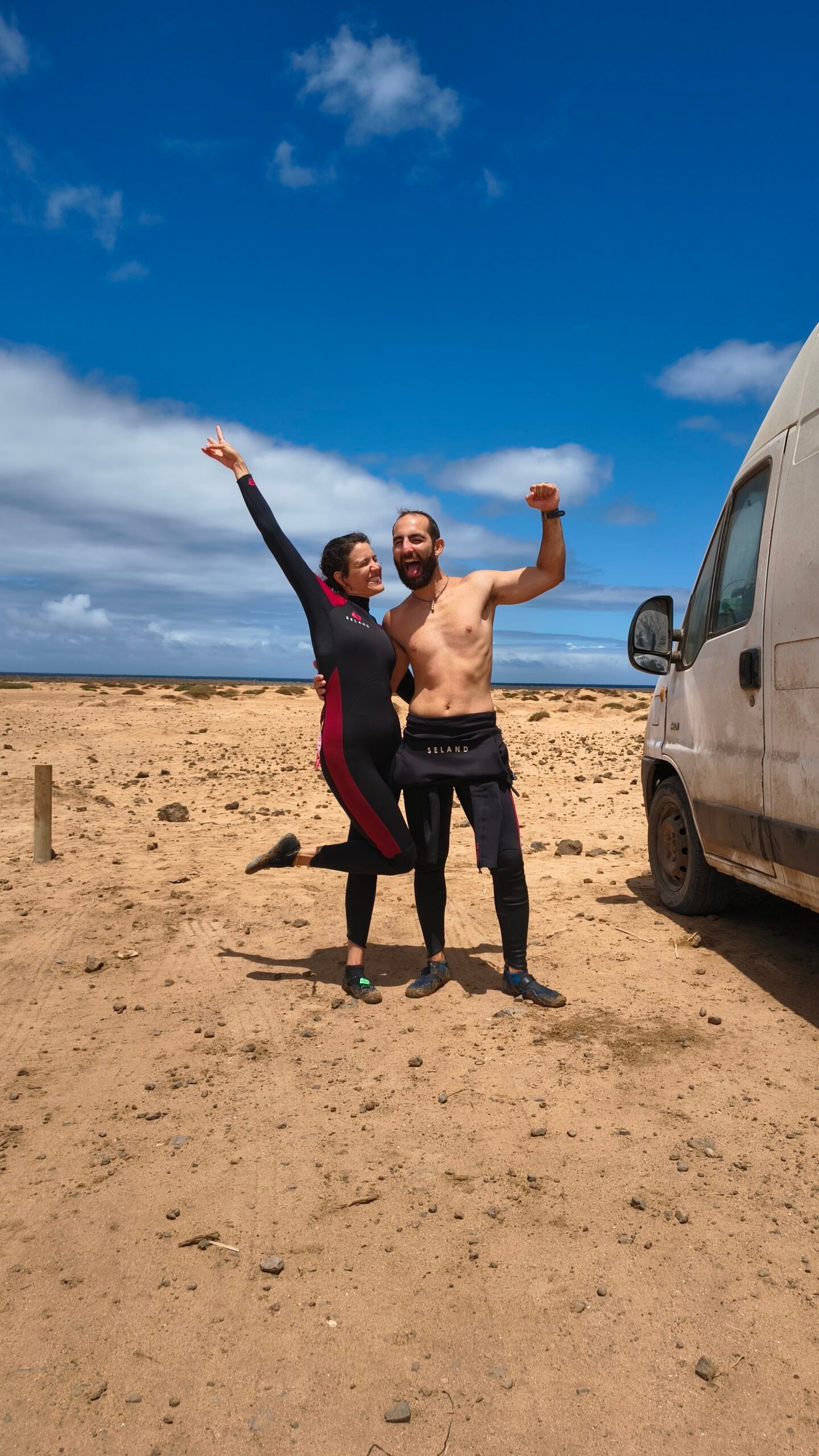 Happy surf students celebrating on the beach in Fuerteventura