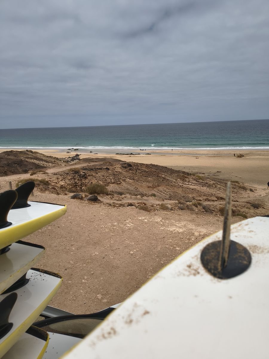 Surfboards ready for a surf lesson above the beach in Fuerteventura