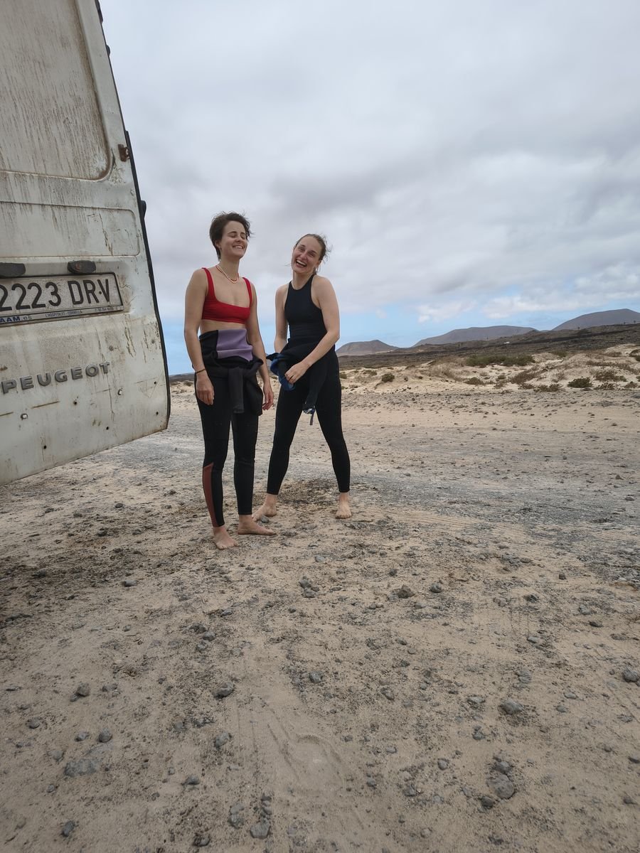 Surf students getting ready for a lesson next to the surf van in Fuerteventura