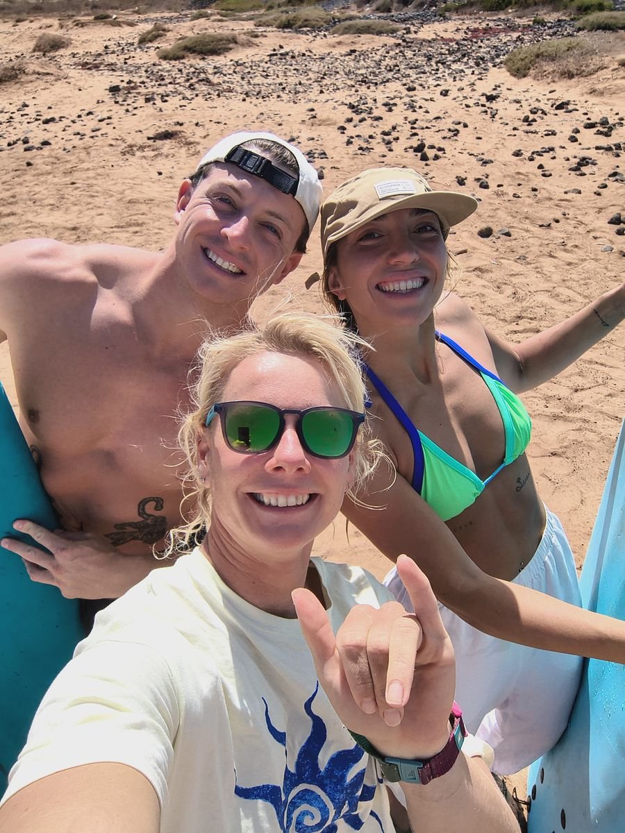 Surf coach and students taking a selfie on the beach in Fuerteventura