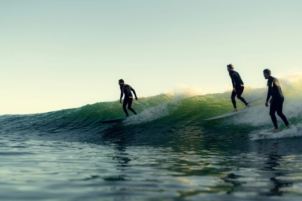 Three surfers riding the same wave – group surf lessons in Corralejo