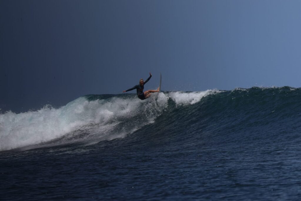 Surfer riding a wave at dusk off the coast of Fuerteventura