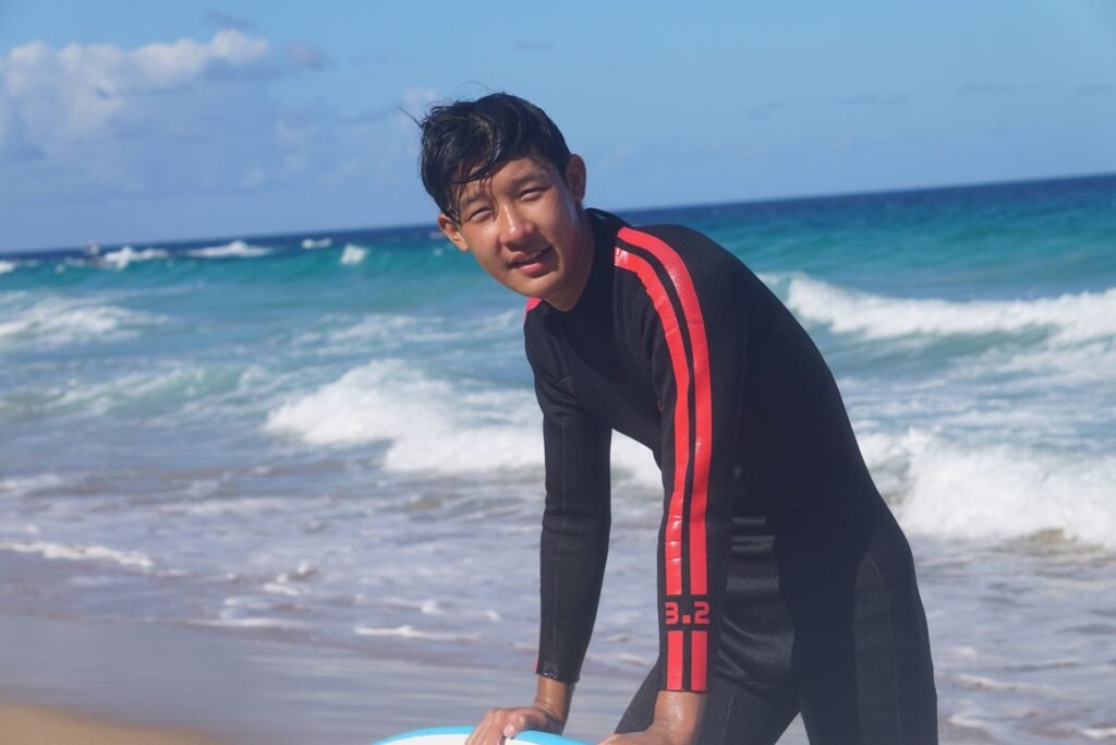 Teen surf student smiling on the beach in Fuerteventura