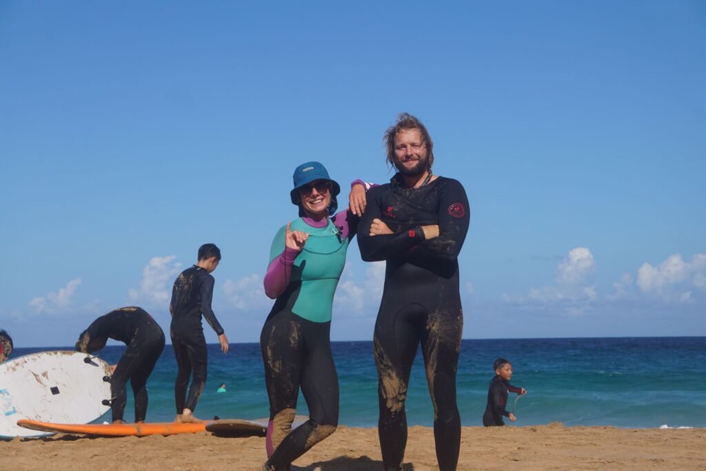 Pure Waves Surf instructors posing on the beach in Fuerteventura